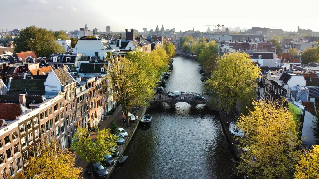 An aerial view of an Amsterdam canal, bridge and canal houses, the kind of location IRIS forecasts